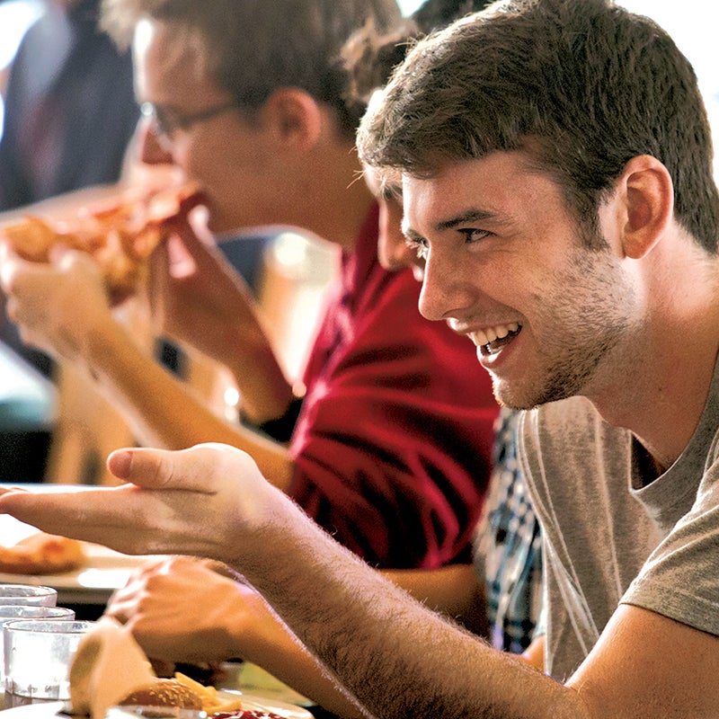Student eating pizza